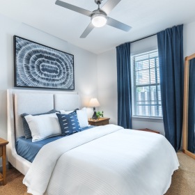 a bedroom with a bed and two nightstands