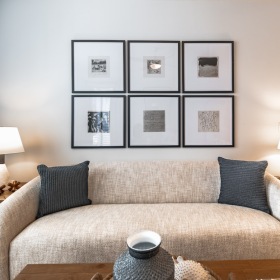 a living room with a couch and wall art
