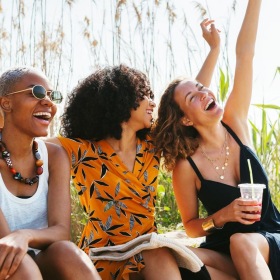 a group of people sitting on a beach