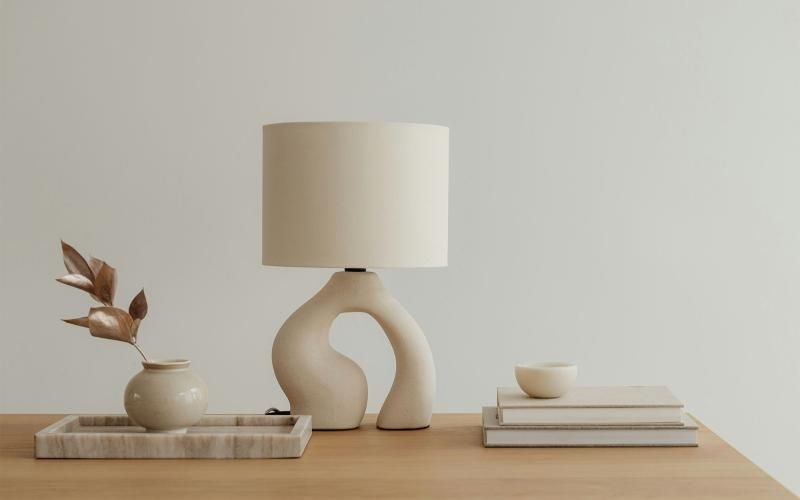 a lamp, stack of books, and decor