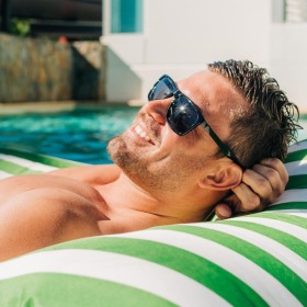 a man lying in a pool float